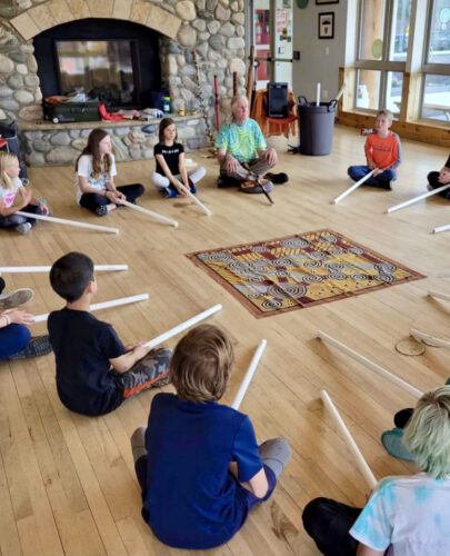Paul Taylor facilitating workshop teaching elementary school students the art of making boomerangs and didgeridoos