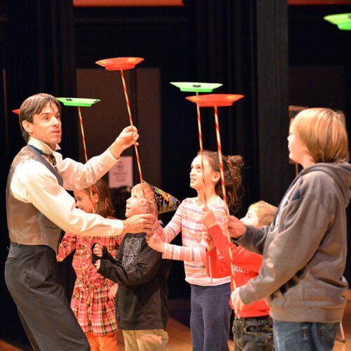 Teaching Artist Peter davison teaching students how to juggle plates