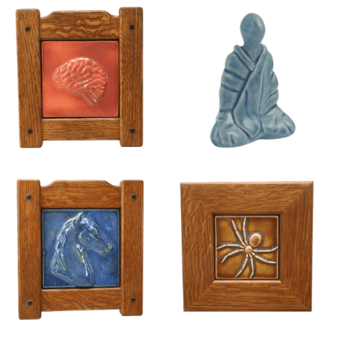 3 Ceramic pieces with wood frames (brain, spider, and horse), and one blue ceramic figure wrapped in cloth