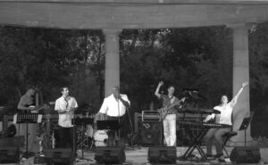 Michael Friedman performs with his band on a stage.